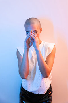 Shaved head fashion model with dramatic colored studio light