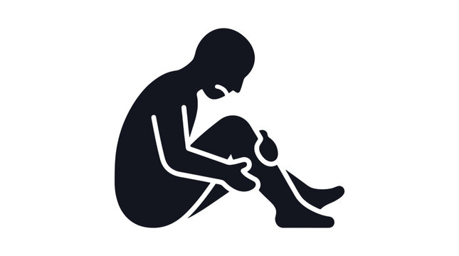 A person sitting with their head down.