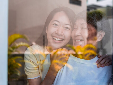 Loving embrace between Asian mother and daughter