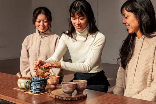 Japanese tea ritual with women preparing and sharing matcha
