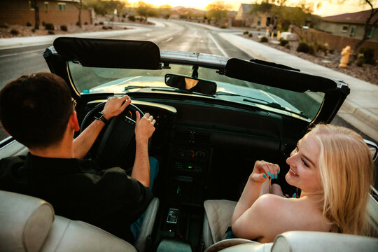 Man and woman in convertible