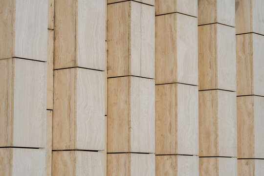 Modern building facade detail with repeating stone panels