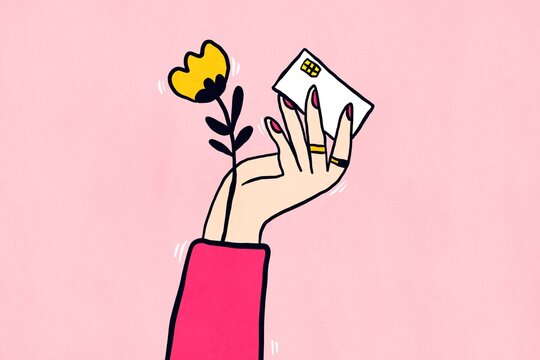 Hand holding gift envelope and flower on pink background