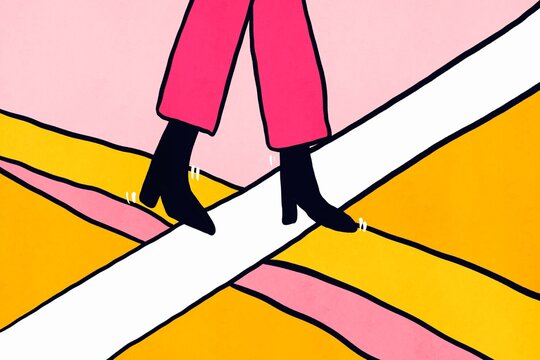 Stylish woman crossing street on bright striped crosswalk