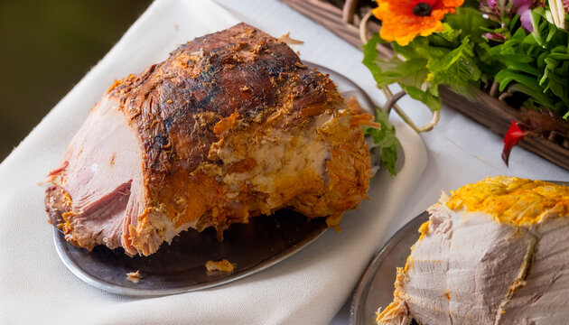 Roasted pork ham and sliced meat platter at buffet table