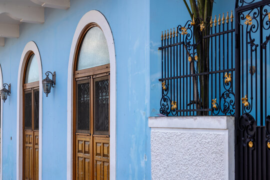 Colonial blue facade with arched wooden doors in Casco Viejo