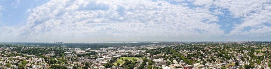 Fototapeta premium Wide aerial panorama overlooking urban suburban landscape