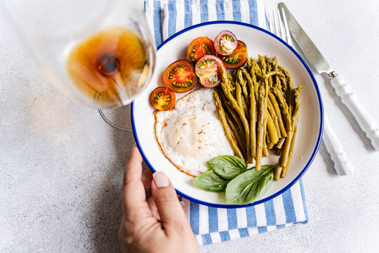 Simple brunch plate with fried egg and fermented asparagus