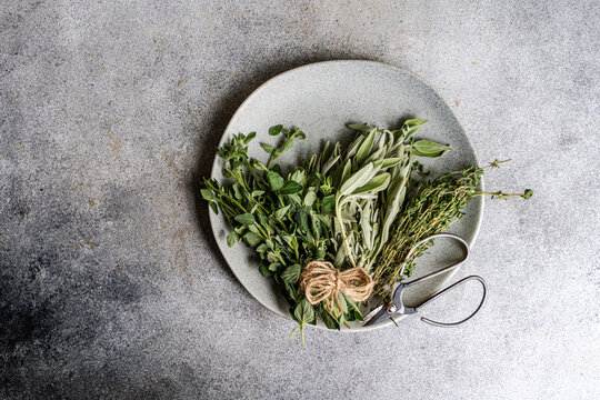 Fresh herbs sage thyme and oregano on a plate