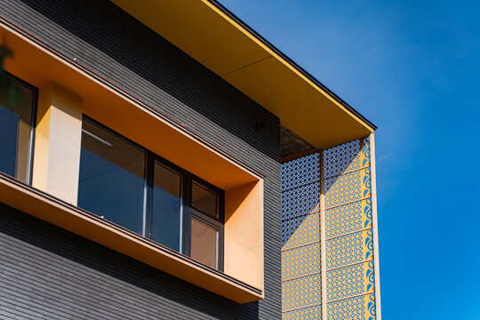 Modern building facade with sunlight, shadow and blue sky