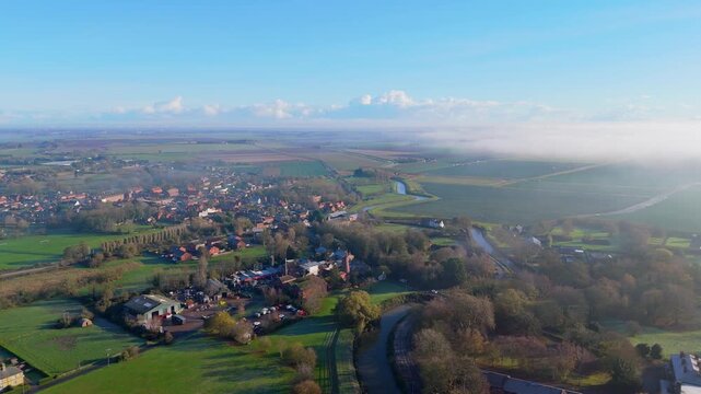 Aerial view of a pea. Village at sunset with new crops on farmland fields winter, Wainfleet, Lincolnshire