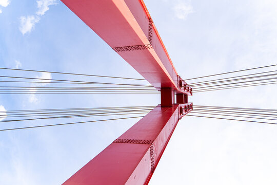 Cable-stayed bridge pylon from below against blue sky