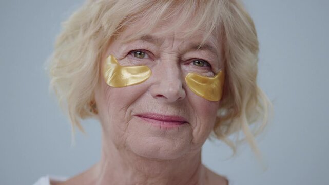 An Elegant Woman with Gold Eye Patches for Luxurious Skin Care and Rejuvenation Treatment