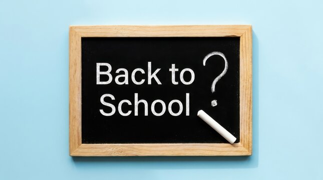 Small chalkboard with the text back to school and a question mark written in white chalk, with a piece of chalk on a blue background