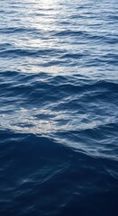 Obraz premium A vast expanse of deep blue ocean water features rhythmic waves cresting under a bright sun, showing the motion and texture of the surface, salt, rhythmic, natural