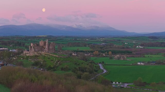 Rock of Cashel at dawn with moon and Galtee Mountains, Ireland