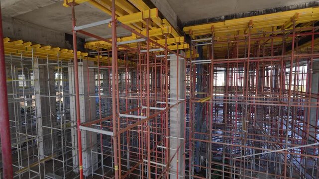 Interior view of temporary steel scaffolding and formwork for concrete floor casting