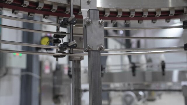 Close-up of metal guide rails on a conveyor belt for empty plastic bottles