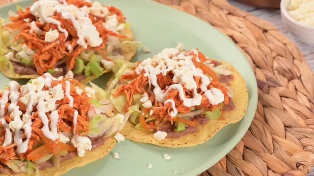 Macro shot of a plate with Mexican chicken tinga tostadas or Mexican toasts