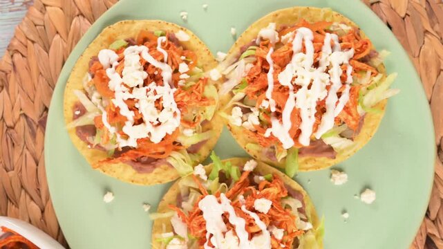 Traditional Mexican cuisine. Tasty chicken tinga tostadas on a plate