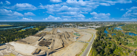Fototapeta premium Aerial panoramic photograph of a large construction site at the Nepean Business Park near the Nepean River in the Western Sydney city of Penrith in New South Wales, Australia