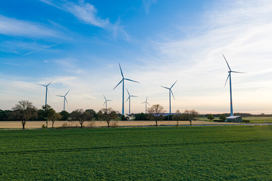 Offshore wind park. Wind turbines farm. Alternative renewable energy generation. Green energy concept. Organic harvest in farm field. Agricultural harvest. Crop cultivation