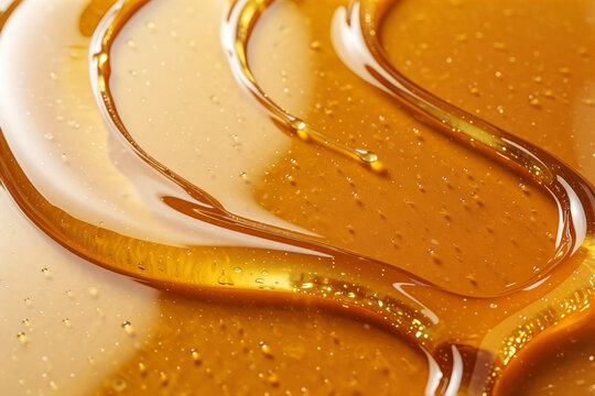Golden honey drizzle texture background