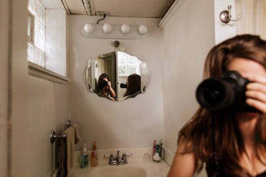 Woman taking photo of herself in a mirror
