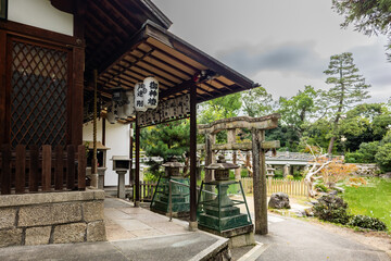 Obraz premium Traditional Japanese garden with wooden house surrounded by trees in serene imperial setting, Kyoto, Japan 