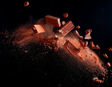 flying pieces and powder of broken red brick