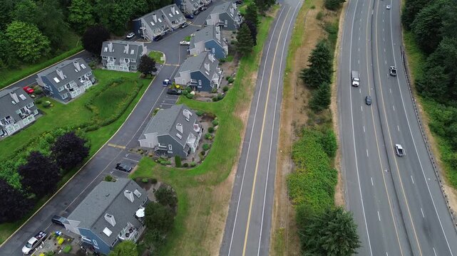 Residential townhome complexes border heavy traffic along Interstate 5. Elevated perspectives reveal architectural density situated near major regional commuting routes found throughout Washington