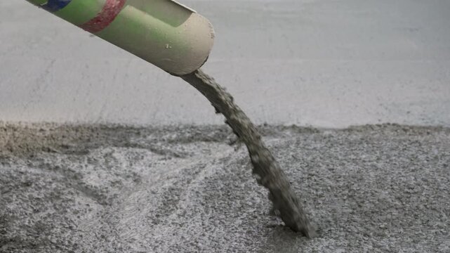 Pumping fresh concrete onto reinforced slab during construction