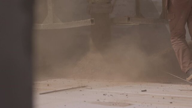 Expanded clay aggregate pouring with dust during roof insulation work