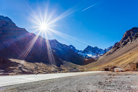 Scenic view of Ruta 7 highway leading to Christ the Redeemer Tunnel, connecting Mendoza, Argentina to Chile through the sunny, majestic Andes Mountains