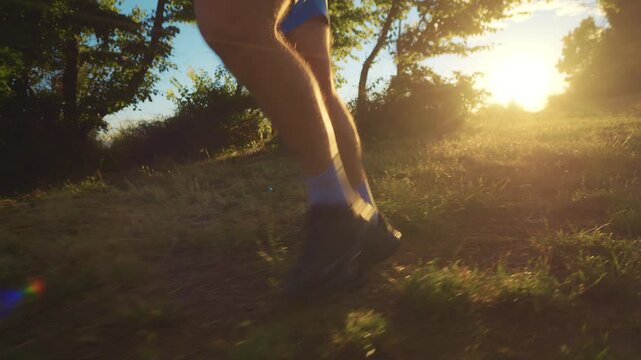 A senior adult jogs along a sunlit trail, surrounded by greenery. The low-angle shot captures their determined stride, emphasizing a healthy lifestyle.