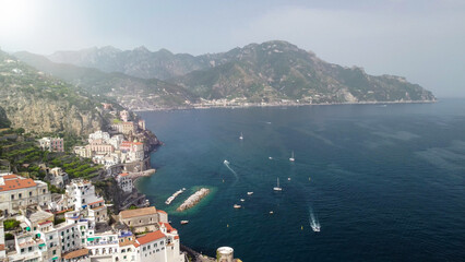 Obraz premium High altitude drone capture of Amalfi town and rugged coastline in Campania