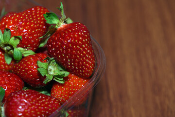 strawberries, juicy, ripe berries. bowl with red strawberries close-up. Fragaria. A plate full of strawberries on the table, macro photo. harvest season, summer vitamins. background, space for text © Oleksandr Filatov