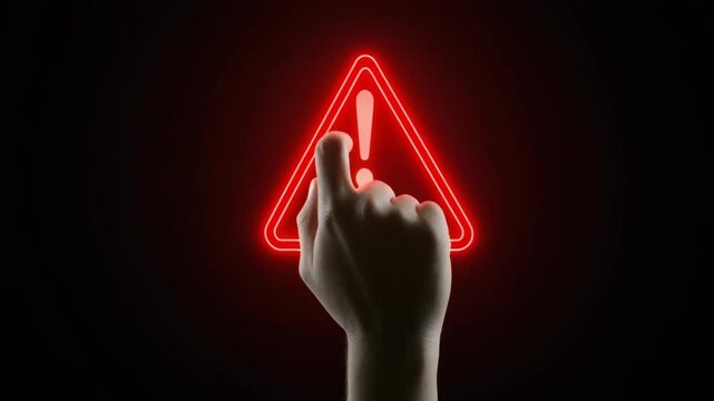 Human finger points to glowing red triangle warning symbol during dark cinematic motion