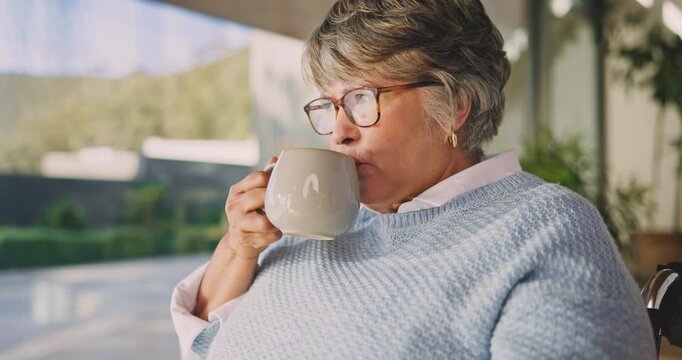 Coffee, senior and woman in wheelchair in home to relax, thinking or enjoy morning beverage. Retirement, drink and person with disability at house, reflection or remember past with window view