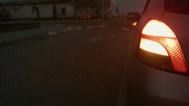 Emergency light of a car stopped on the road at night due to a breakdown