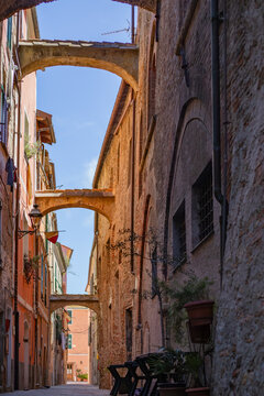 Medieval houses in Albenga, characterized by narrow alleys called carrugi, and arches, support bridges between the houses in the historic center, in the province of Savona, Liguria ,Italy