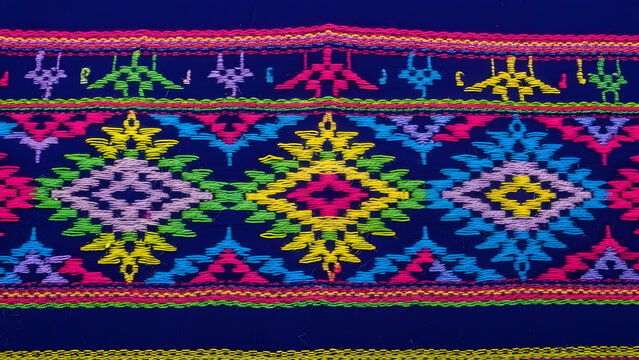 Vibrant Traditional Ethnic Geometric Textile Pattern with Colorful Embroidery on Dark Blue Fabric