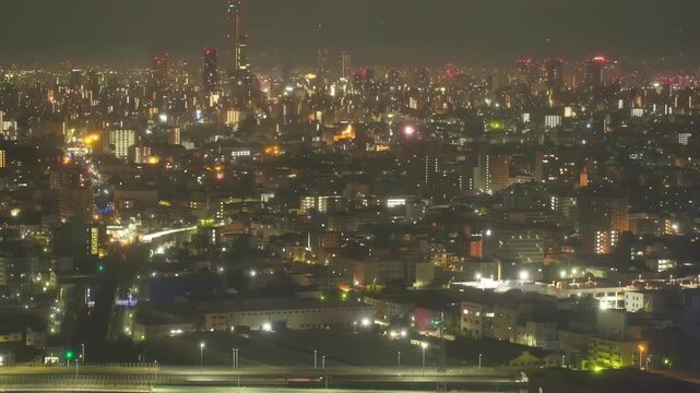 Timelapse view of Tokyo at night with dense urban skyline and glowing city lights in Japan. High-rise buildings and illuminated streets create a vibrant metropolitan atmosphere.