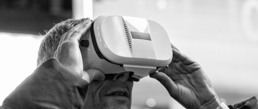 Excited young man wearing a pair of VR glasses exploring Times Square