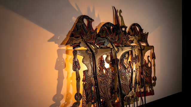 Traditional Indonesian Wayang Kulit shadow puppets illuminated, showcasing intricate craftsmanship and cultural heritage