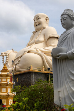Giant statues of Laughing Buddha in Vinh Trang Pagoda at My Tho, Vietnam