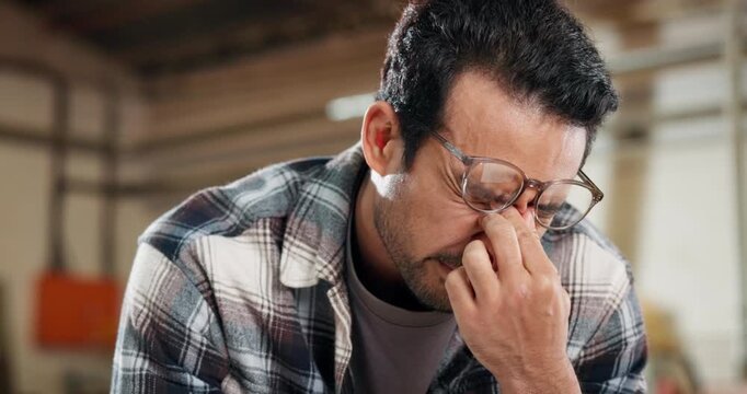 Stress, man and woodworker in workshop with headache for order cancellation, mistake or negative review. Upset, technology and carpenter with email for error feedback on timber manufacturing project.