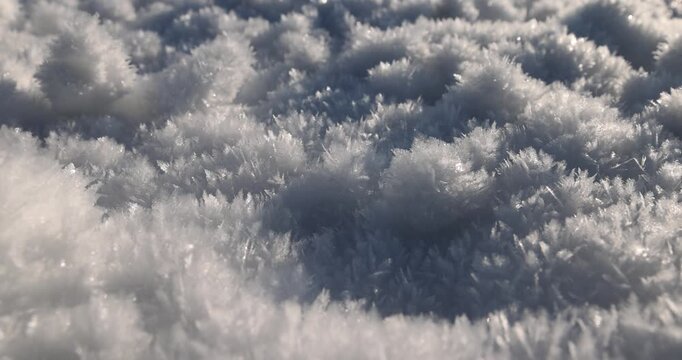 Fluffy frost crystals close-up, frost crystals cover the surface of snow on a frosty winter day close-up
