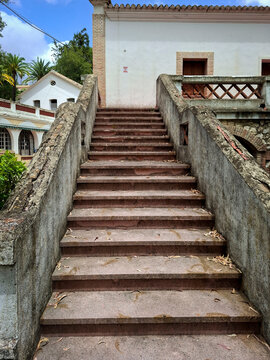 Weathered concrete staircase leading to an abandoned building in Borja sanatorium
