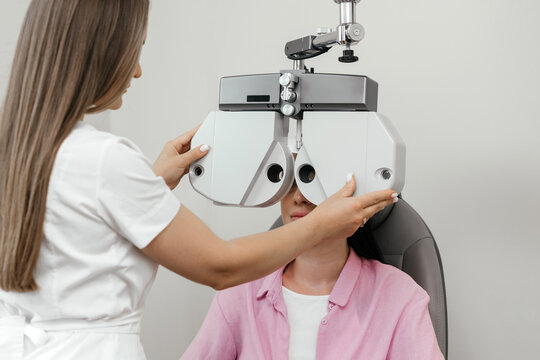 Optometrist performing computerized vision screening with an autorefractor for accurate eye diagnostics and refractive error assessment